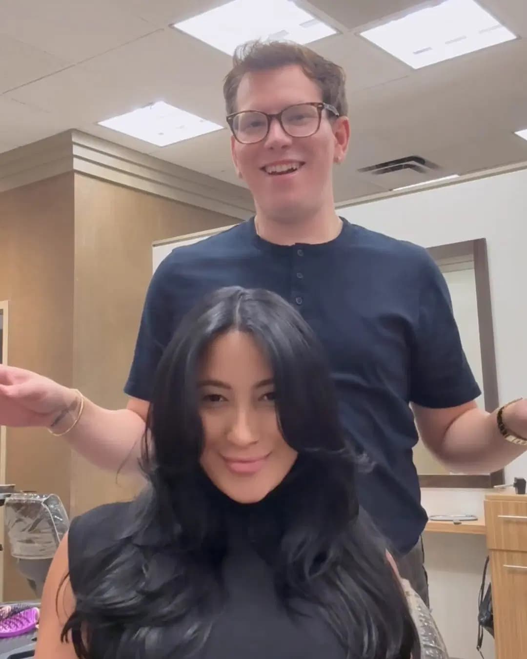 Voluminous blowout on long dark hair, with Rudy Perez behind the chair