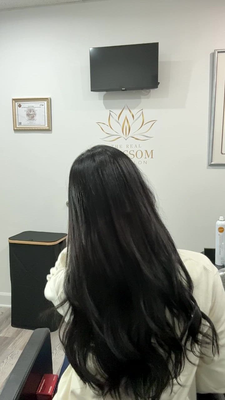 Long black hair in soft waves, turned from the back